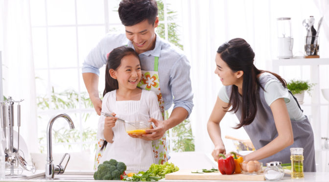 dad and daughter making a healthy meal together