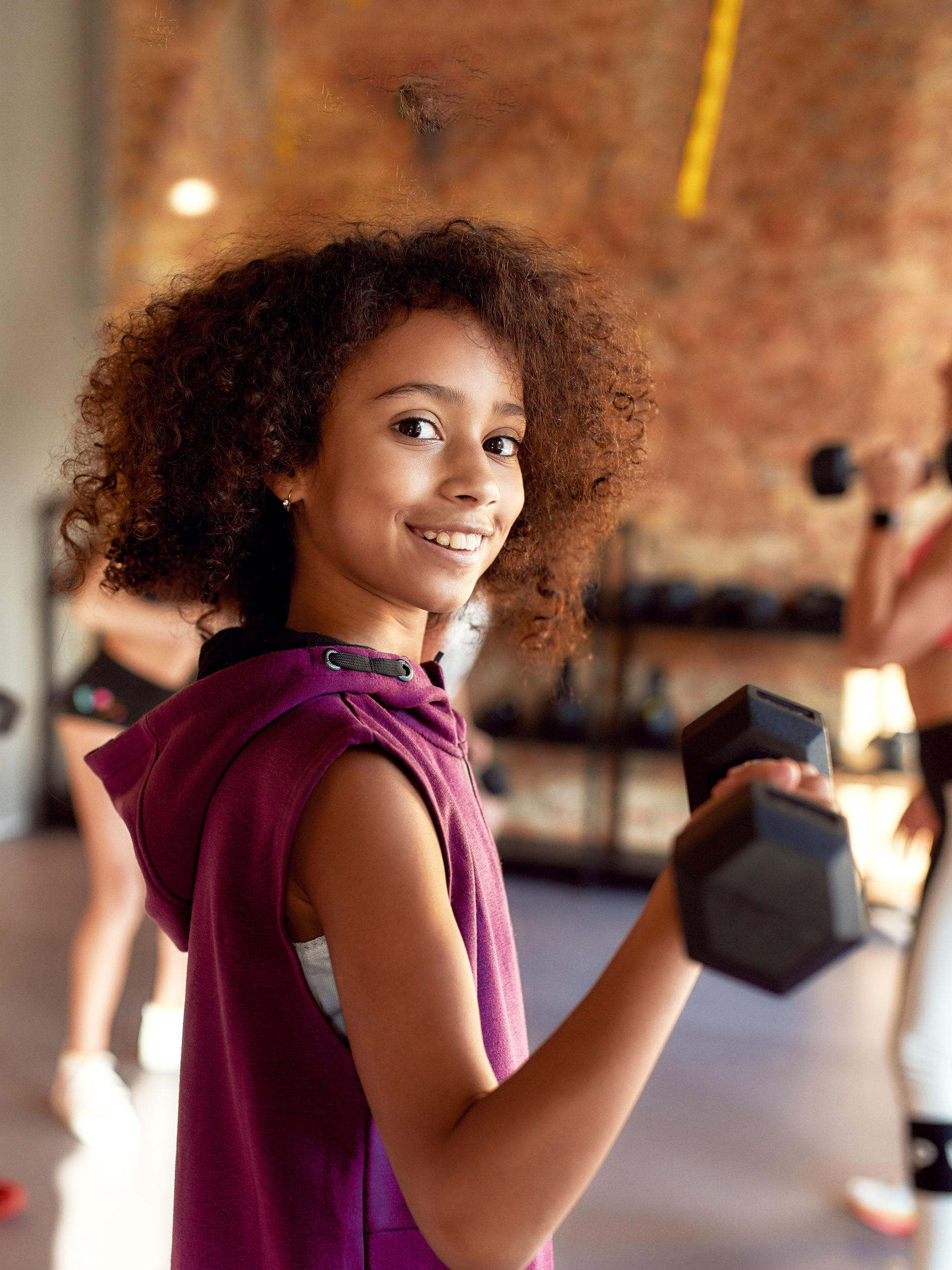 girl with weight in hand at an exercise class