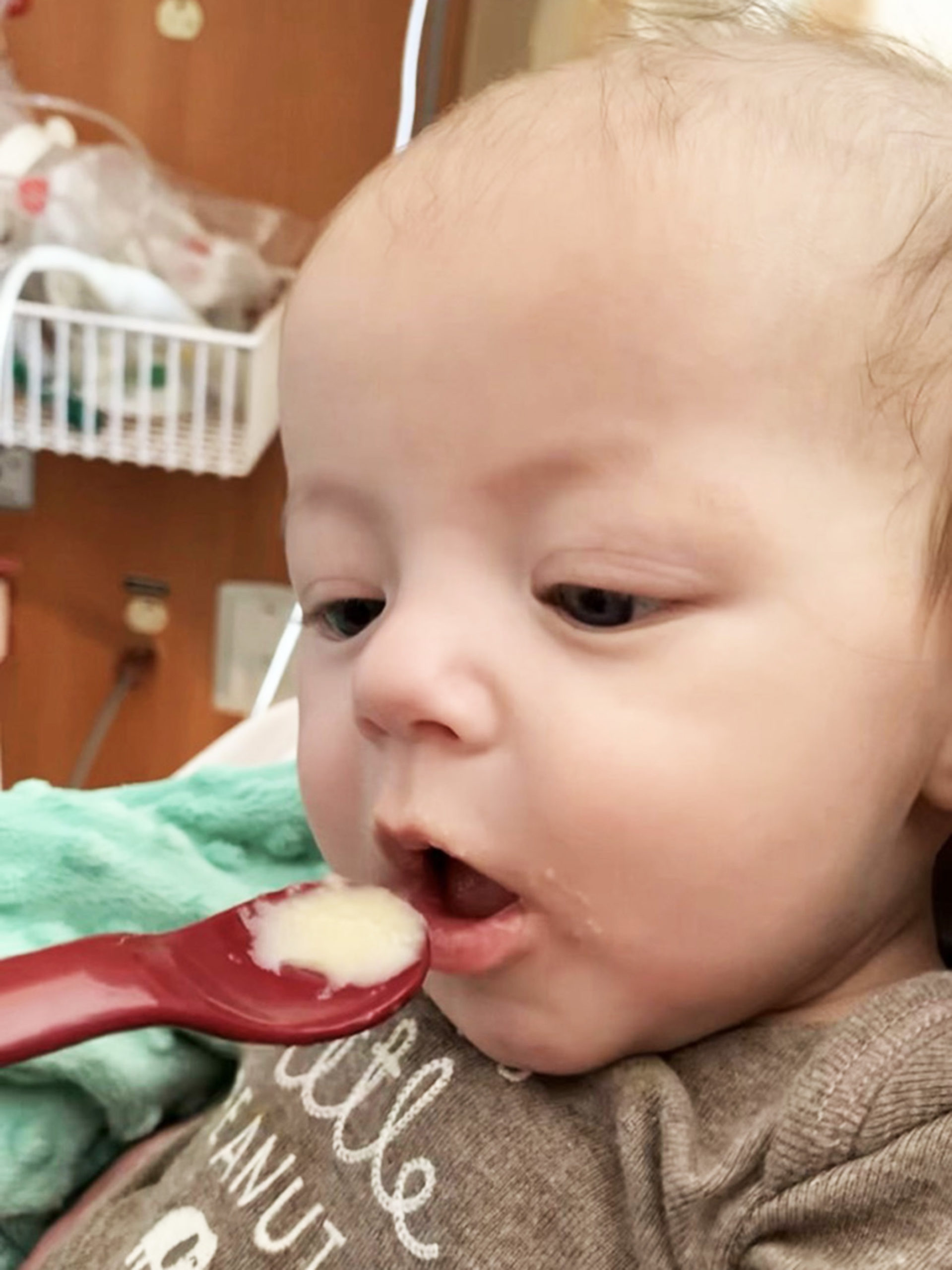 Warren eating from a spoon